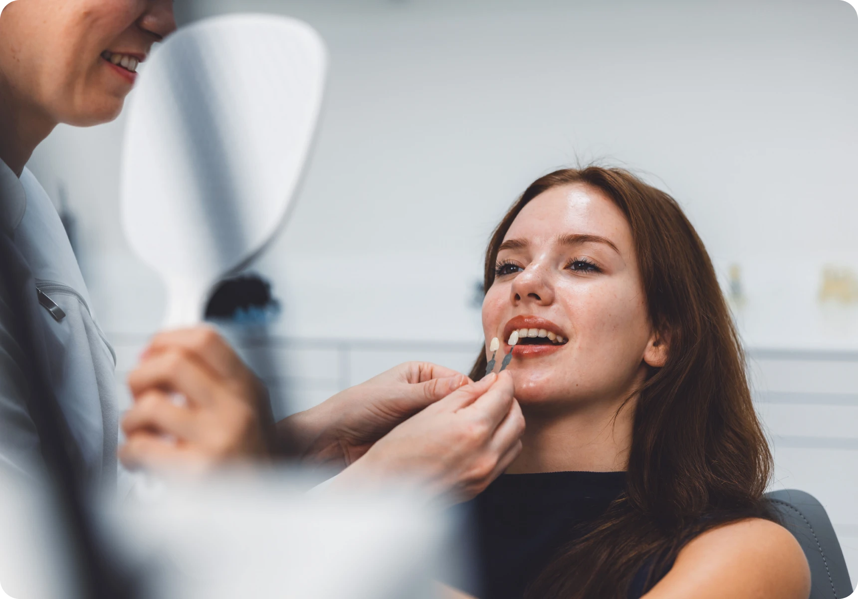 Patient smiling during dental veneer fitting